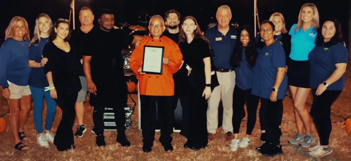 Uday Kadam holding an award from Business Expo 2025 for the best entree award with his team